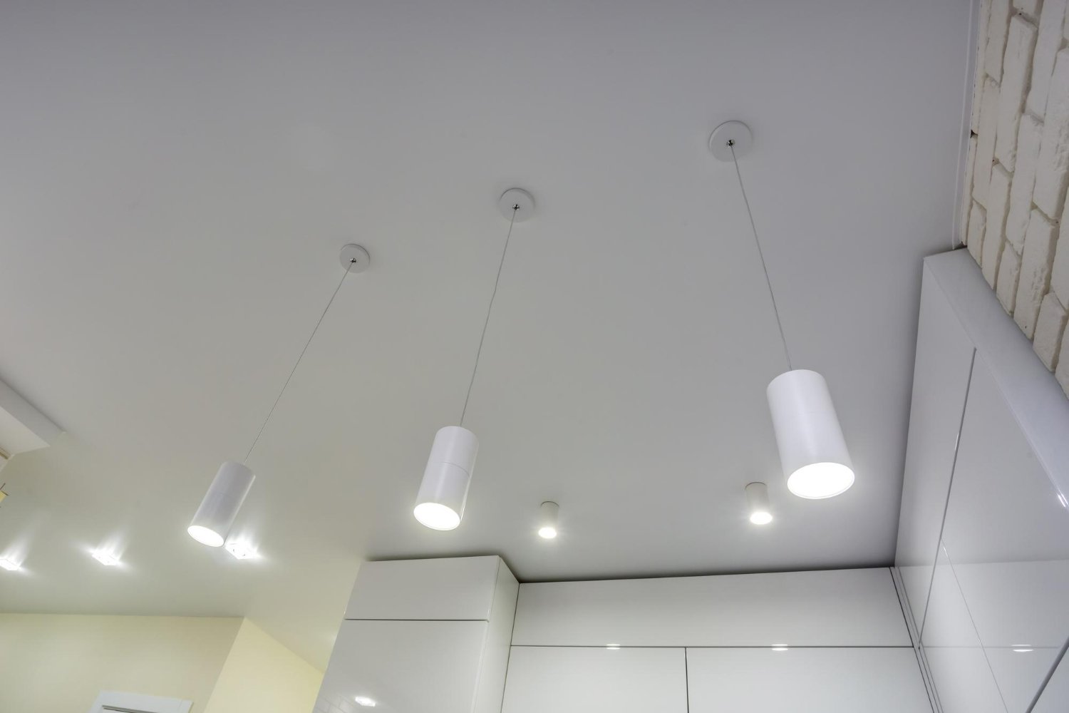 Modern spotlight ceiling lights with adjustable heads mounted on a white ceiling. 