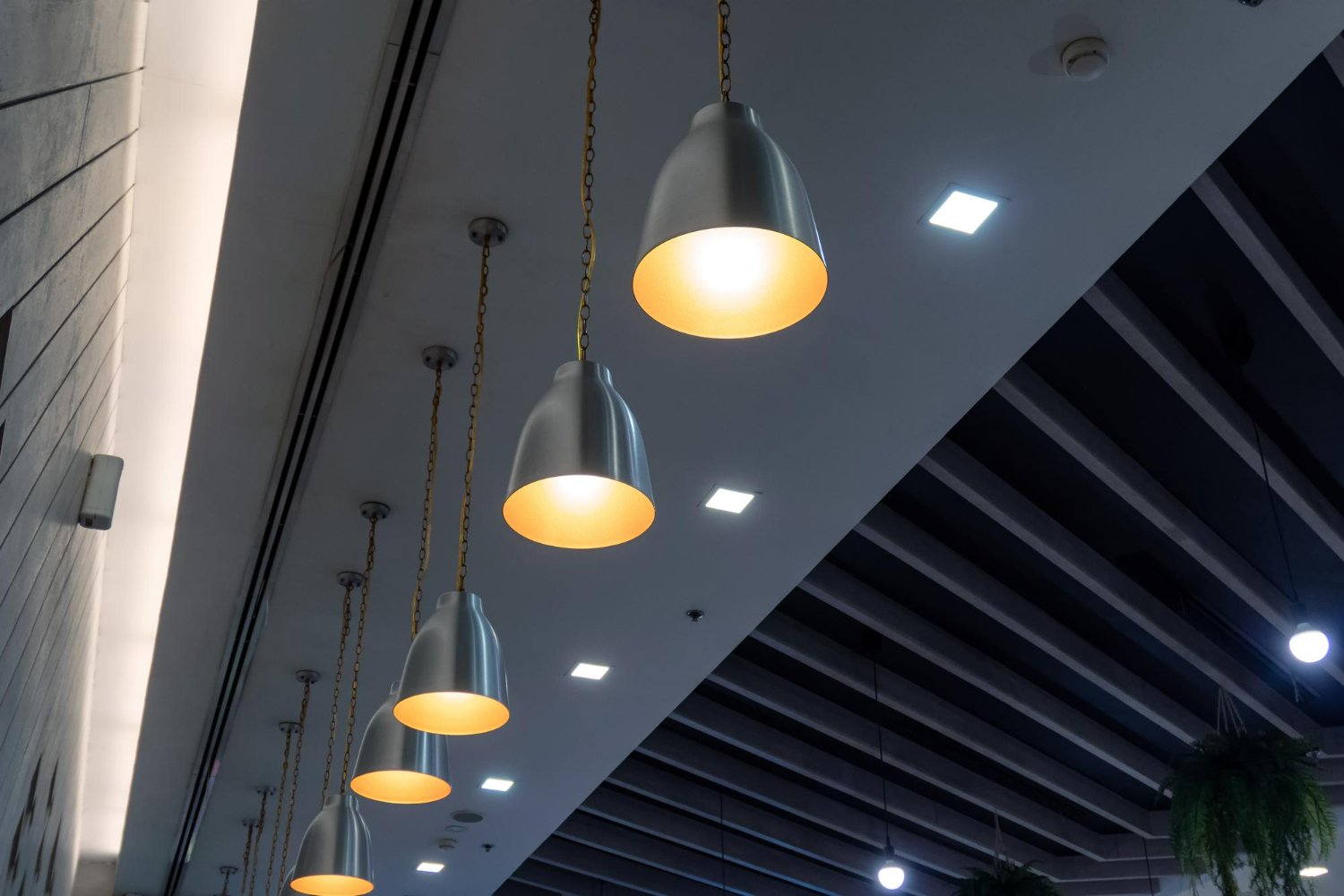 Modern spotlight ceiling lights with adjustable heads mounted on a white ceiling. 