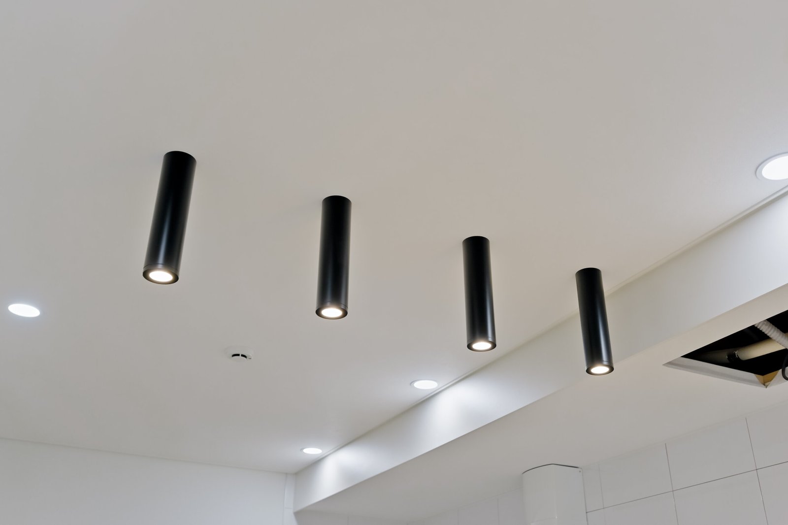 Modern spotlight ceiling lights with adjustable heads mounted on a white ceiling. 