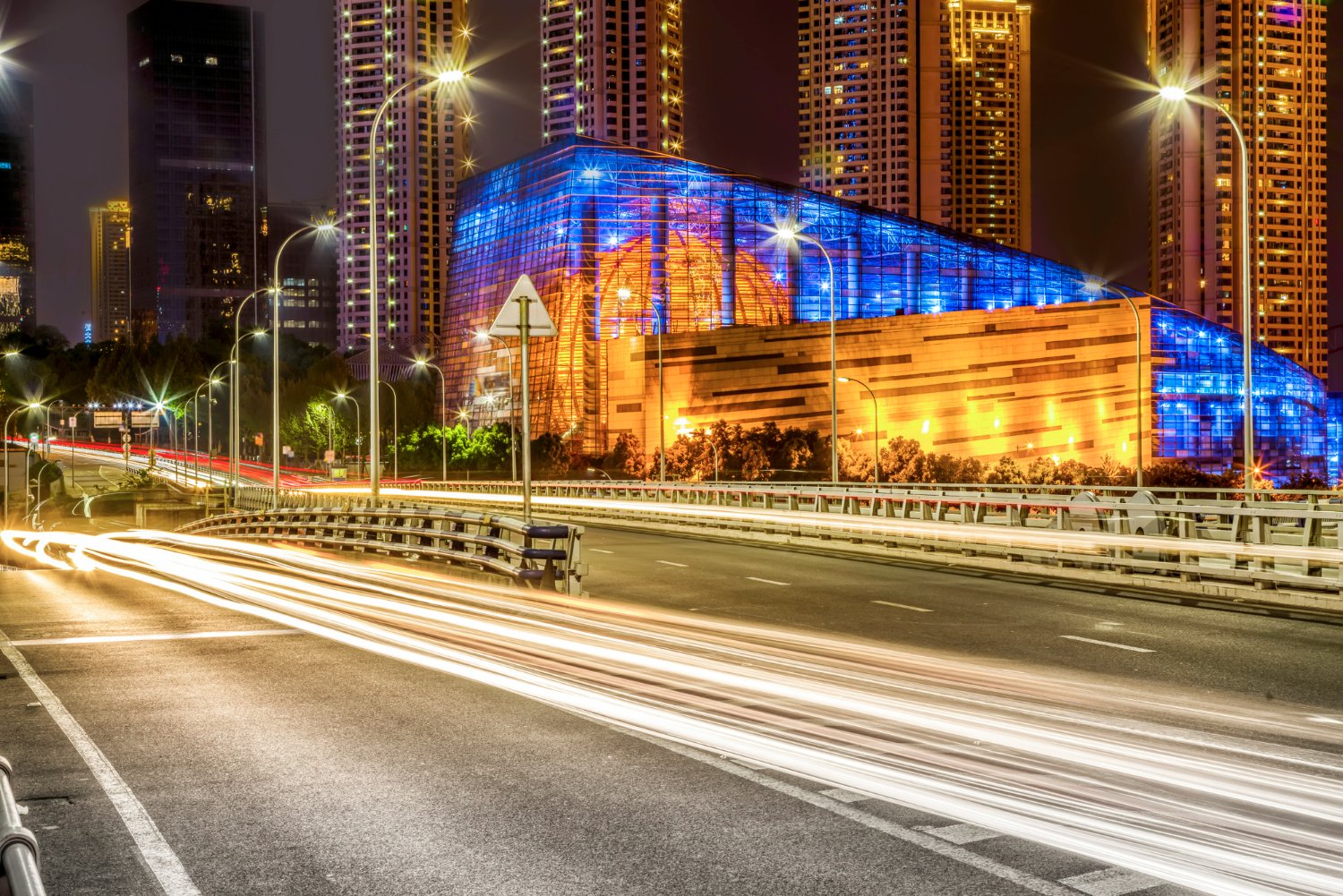 Contemporary facade light illuminating pathways around a building