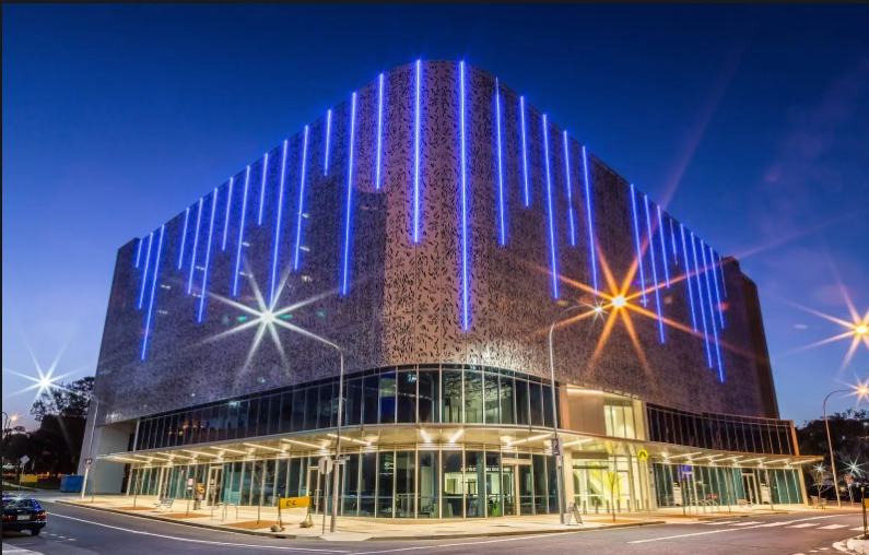 Outdoor facade light enhancing the texture of a brick building